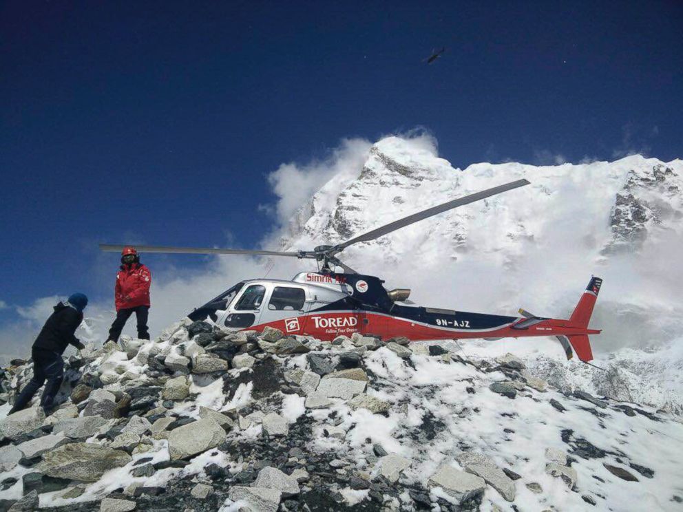 PHOTO: In this photo provided by Azim Afif, a helicopter prepares to rescue people from camp 1 and 2 at Everest Base Camp, Nepal, April, 27, 2015.