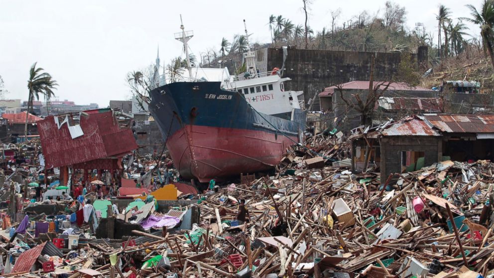A ship lies on top of damaged homes after it was washed ashore in Tacloban city, Leyte province, central Philippines on Sunday, Nov. 10, 2013. 