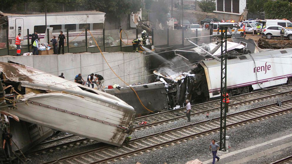 Emergency personnel respond to the scene of a train derailment in Santiago de Compostela, Spain, Wednesday, July 24, 2013.