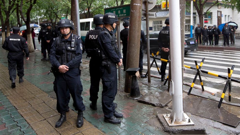 Armed policemen stand guard near the site of an explosion in Urumqi, northwest China's Xinjiang region, May 22, 2014. 