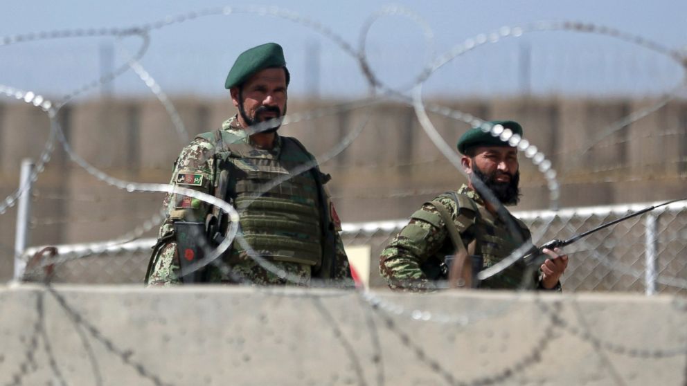 PHOTO: Afghanistan National Army soldiers stand guard at a gate of Camp Qargha, west of  Kabul, Afghanistan, Aug. 5, 2014. 