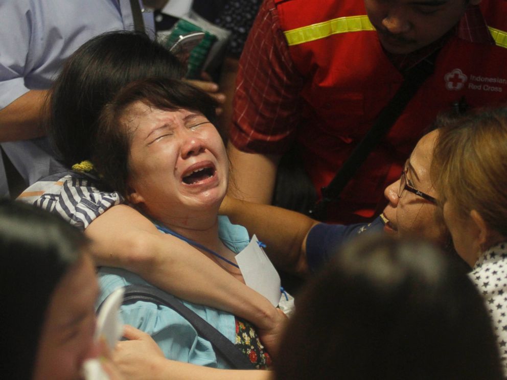 PHOTO: Relatives of passengers of the missing AirAsia flight QZ 8501 react to the news about the findings of bodies in the waters near the site where the jetliner disappeared, at Juanda International Airport in Surabaya, Indonesia, Dec. 30, 2014. 