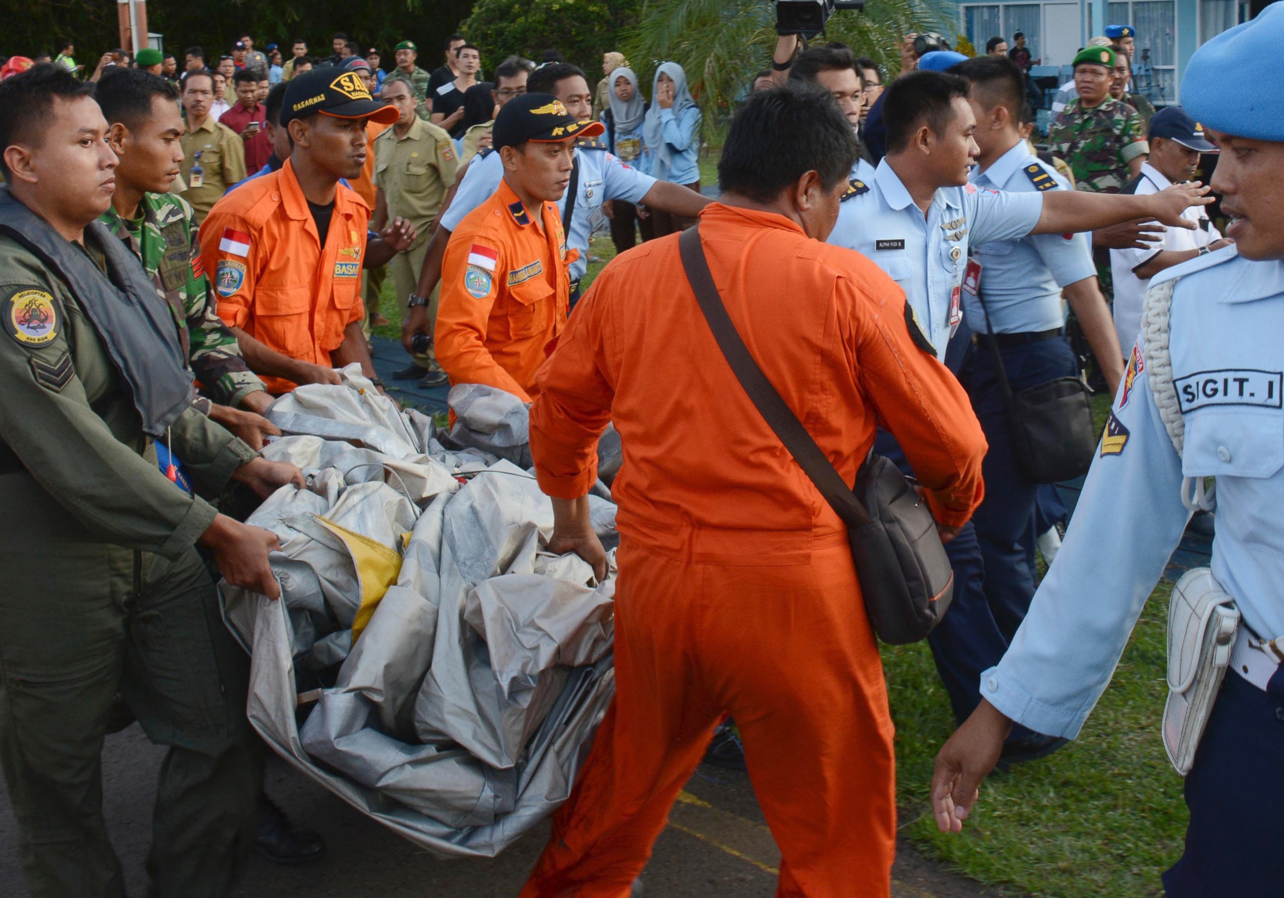 PHOTO: Indonesian Air Force personnel carry debris from AirAsia Flight 8501 at the airbase in Pangkalan Bun, Central Borneo, Indonesia, Dec. 30, 2014. 