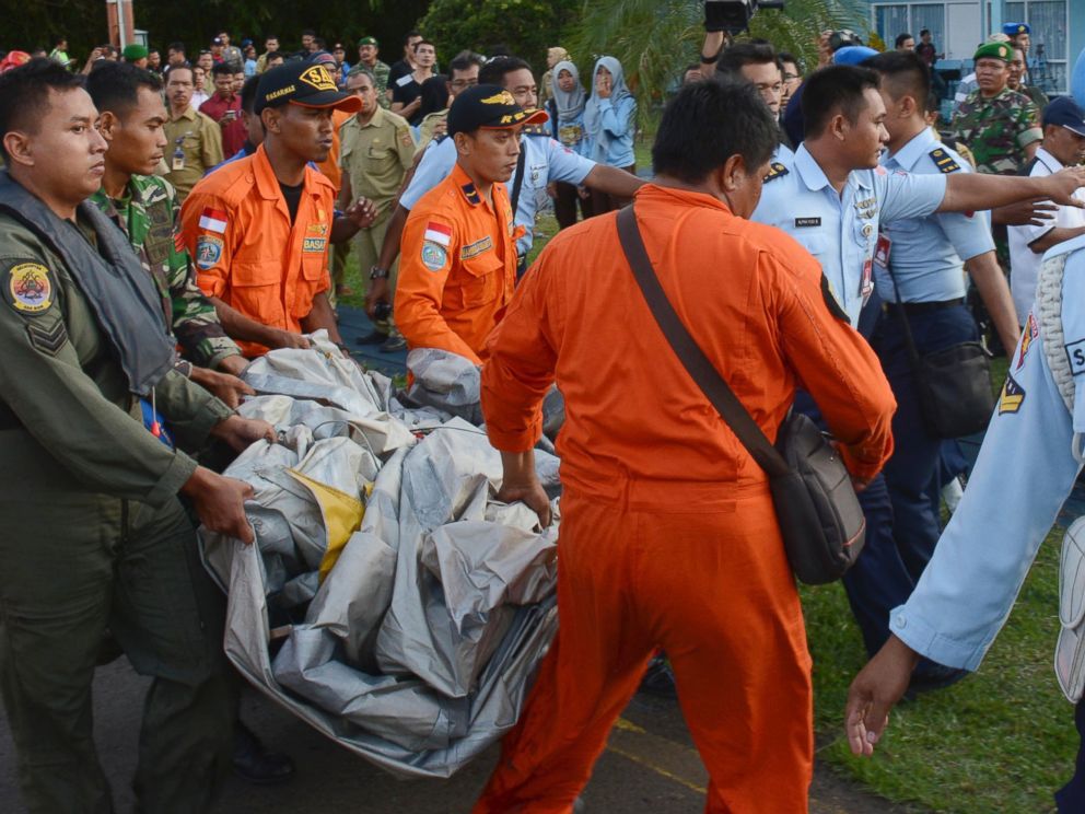 PHOTO: Indonesian Air Force personnel carry debris from AirAsia Flight 8501 at the airbase in Pangkalan Bun, Central Borneo, Indonesia, Dec. 30, 2014.