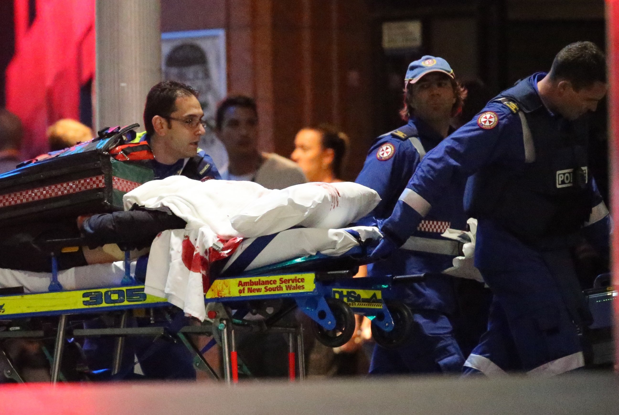 PHOTO: A stretcher is wheeled to an ambulance after shots were fired during  a cafe  siege at Martin Place in the central business district of Sydney, Australia, Dec. 16, 2014. 