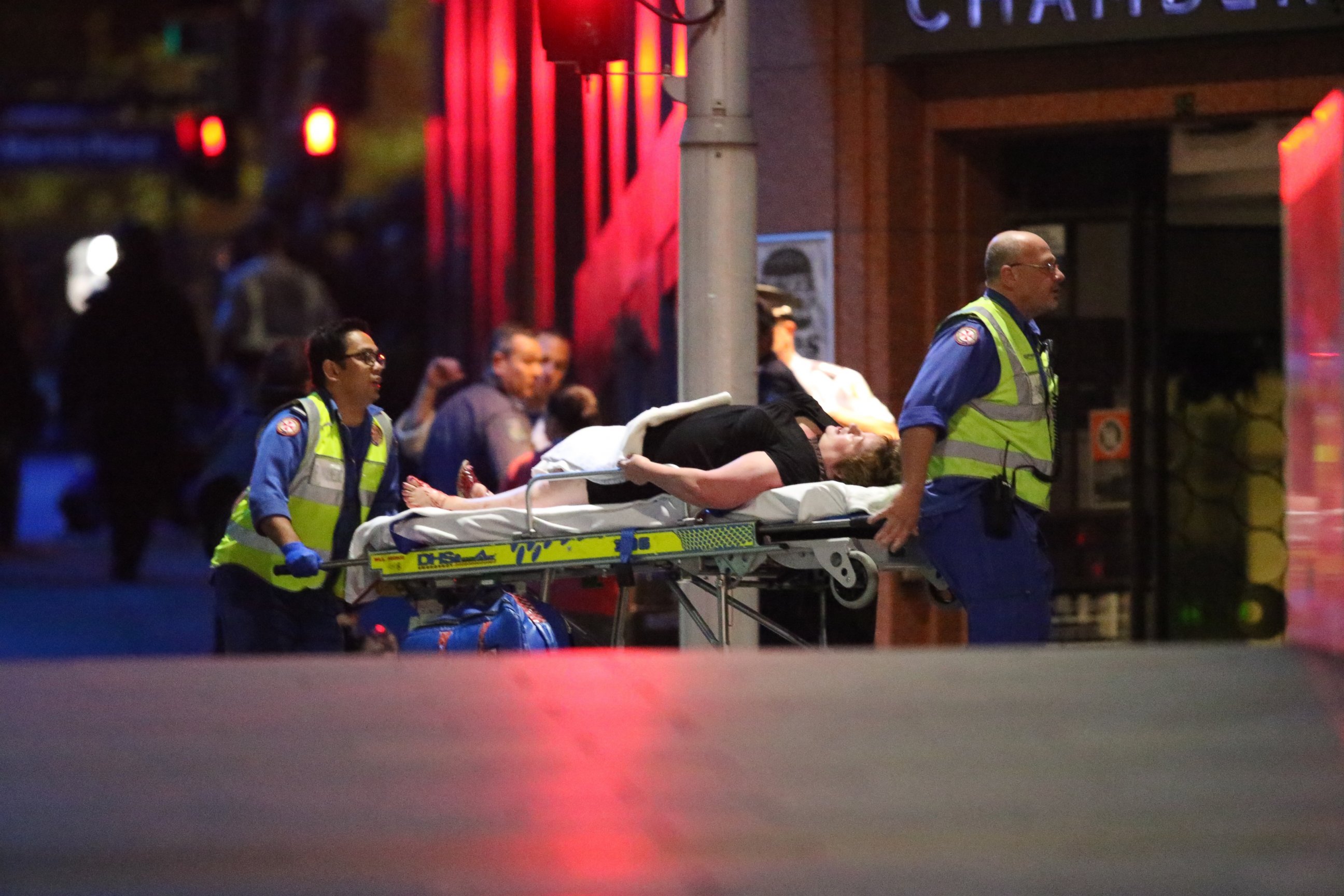 PHOTO: A injured hostage is wheeled to an ambulance after shots were fired during  a cafe  siege at Martin Place in the central business district of Sydney, Australia, Dec. 16, 2014. 
