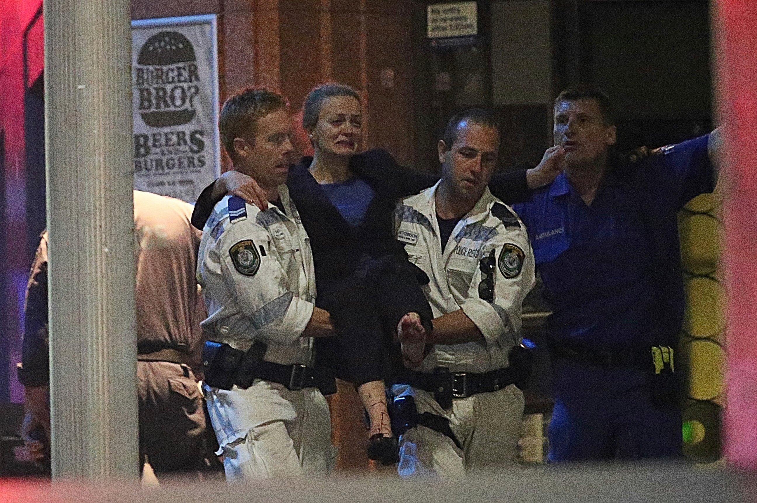 PHOTO: A injured hostage is carried to an ambulance after shots were fired during  a cafe siege at Martin Place in the central business district of Sydney, Australia, Dec. 16, 2014. 