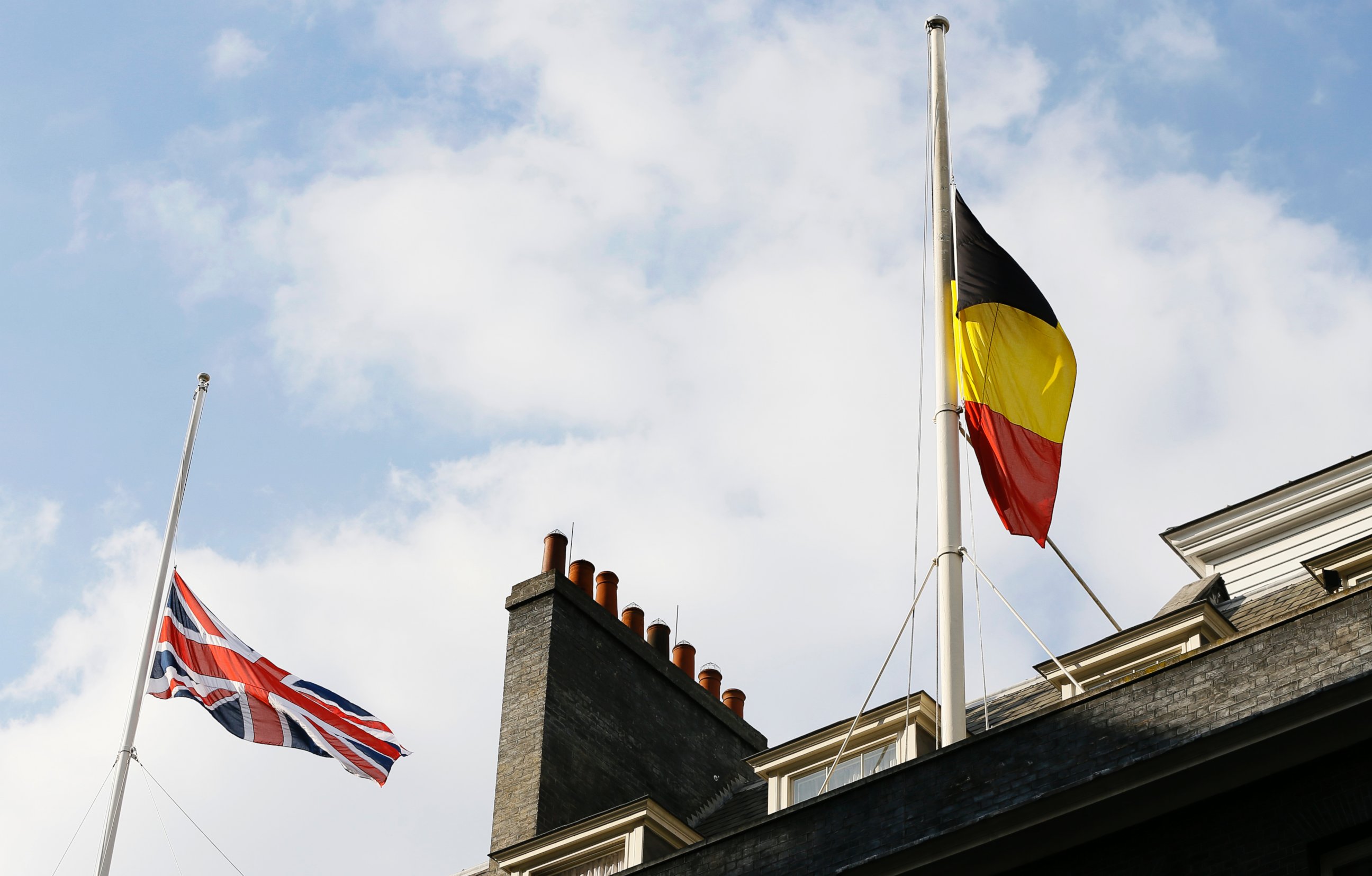 PHOTO: The Belgium and British flag fly at half staff above Downing Street in London, following the attacks in Brussels, March, 22, 2016.
