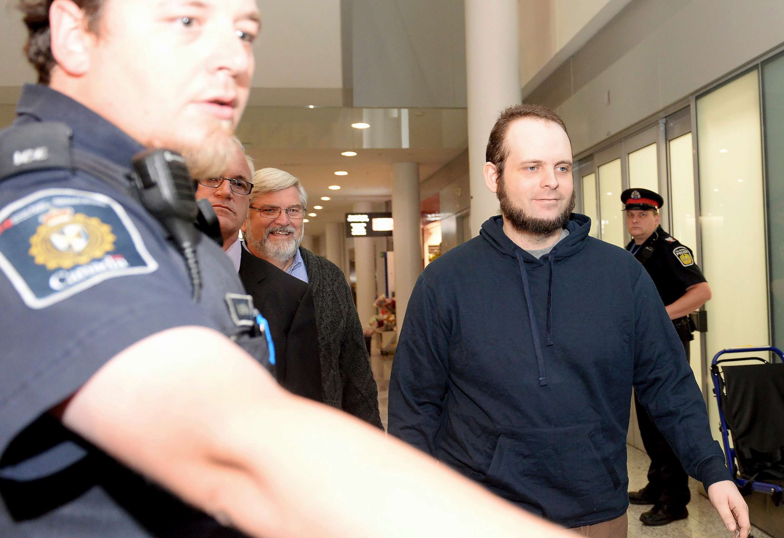PHOTO: Joshua Boyle is escorted by authorities to a media availability at Toronto's Pearson International Airport on Friday, Oct. 13, 2017.