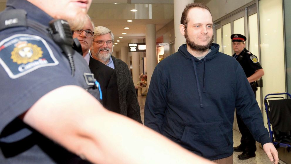 PHOTO: Joshua Boyle is escorted by authorities to a media availability at Toronto's Pearson International Airport on Friday, Oct. 13, 2017.