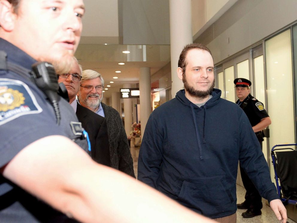 PHOTO: Joshua Boyle is escorted by authorities to a media availability at Torontos Pearson International Airport on Friday, Oct. 13, 2017.