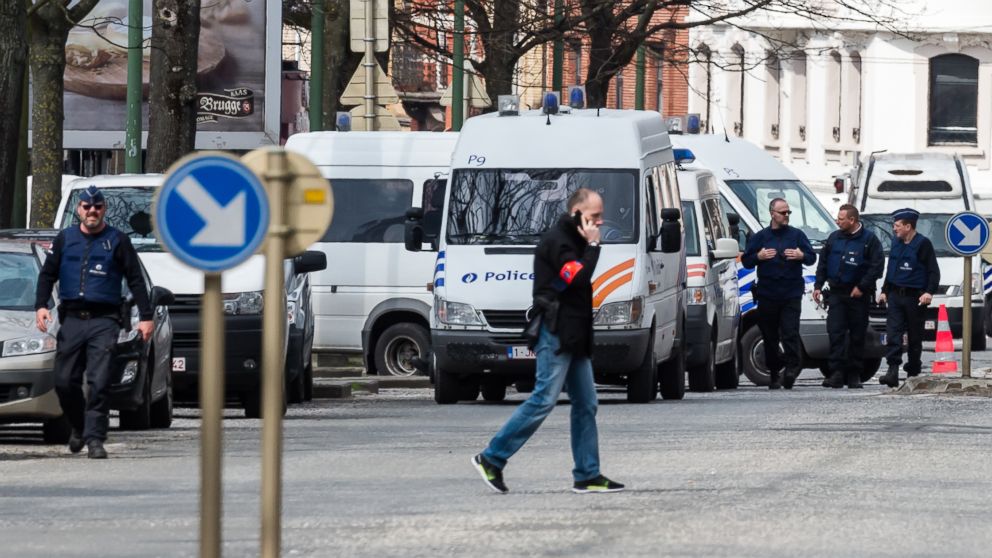 Police secure an area during a house search in the Etterbeek neighborhood in Brussels on Saturday April 9, 2016. The arrest Friday of six men suspected of links to the Brussels bombings, including the last known fugitive in last year's Paris attacks, raised new questions about the extent of the Islamic State cell believed to have carried out the intertwined attacks that left 162 people dead in two countries.