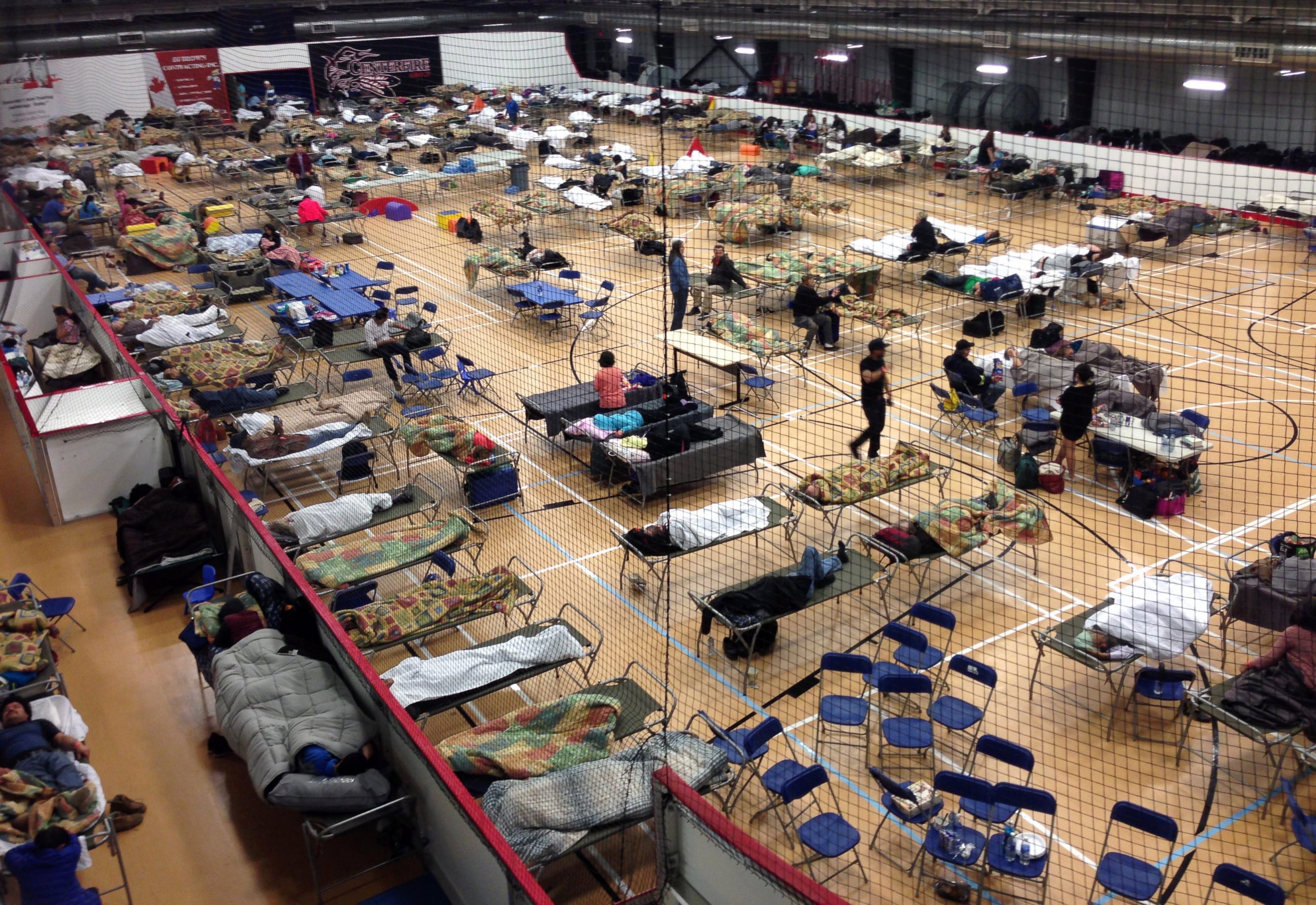 PHOTO: Cots are set up on the gym floor at an evacuee reception center, operated by the regional municipality of Wood Buffalo in Anzac, Alberta, Canada on Wednesday, May 4, 2016.