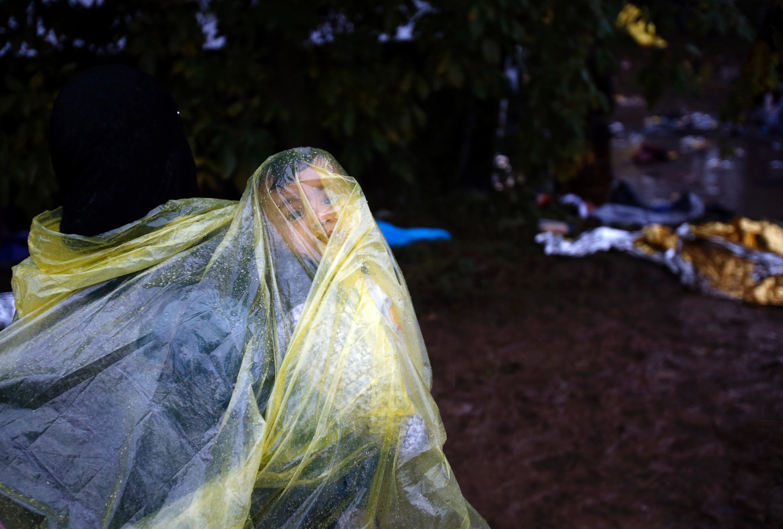 PHOTO: A migrant woman carrying a baby heads to cross a border line between Serbia and Croatia, near the village of Babska, Croatia, Oct. 19, 2015.
