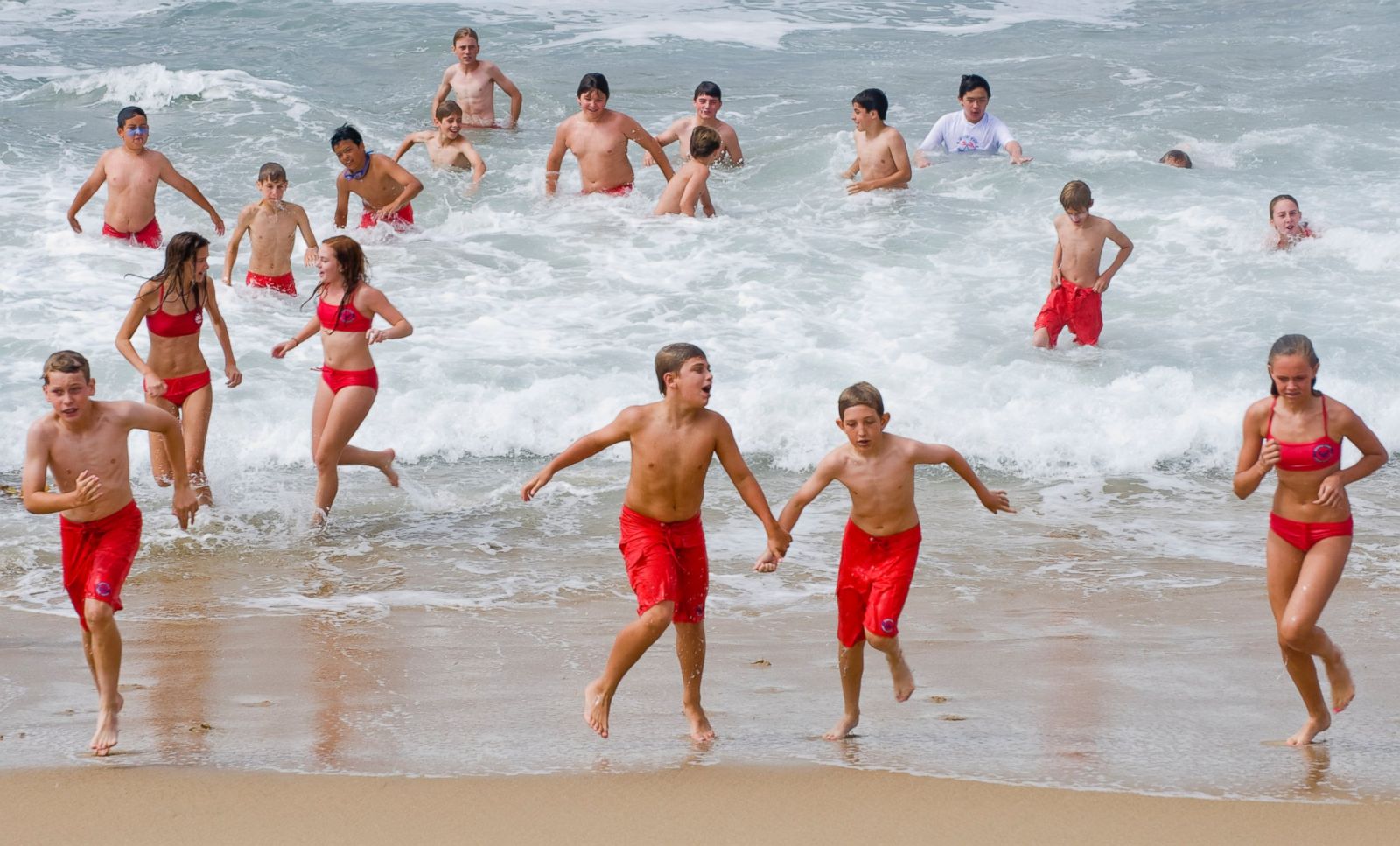 Some of class of Newport Beach Junior Lifeguards exit the ocean, June 23, 2...