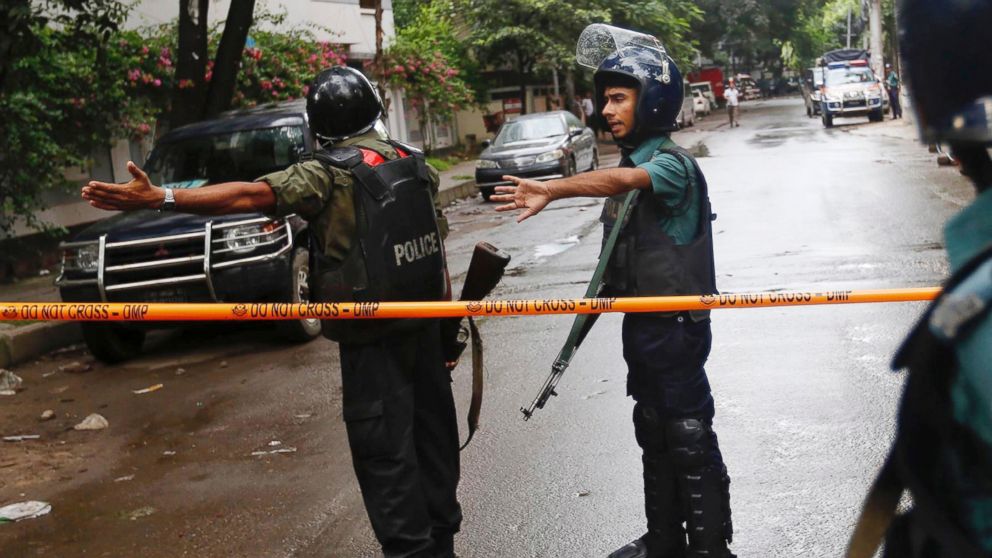 Bangladeshi policemen clear out an area to facilitate action against heavily armed militants who struck at the heart of Bangladesh's diplomatic zone on Friday night, taking dozens of hostages at a restaurant popular with foreigners, Dhaka, Bangladesh, Saturday, July 2, 2016. Police sustained casualties and dozens of people were wounded in a gun battle as security forces cordoned off the area and sought to end the standoff. 