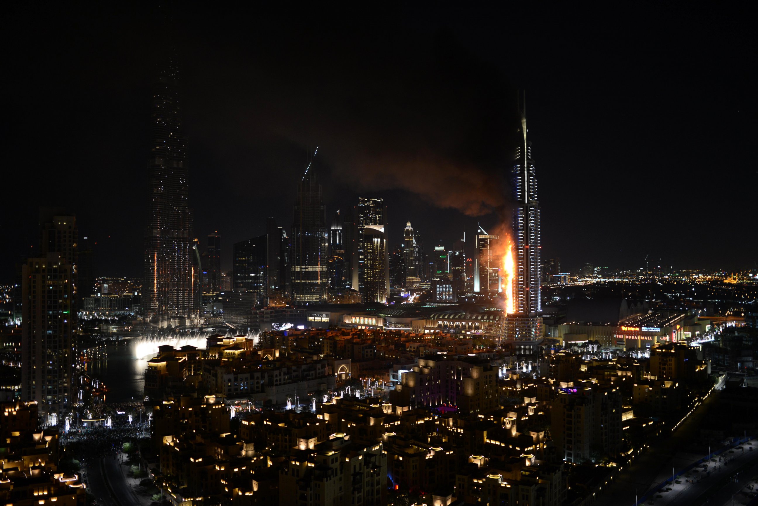 PHOTO: Smoke and flames pour from a building which contains the Address Downtown Hotel, in Dubai, United Arab Emirates, Dec. 31, 2015.