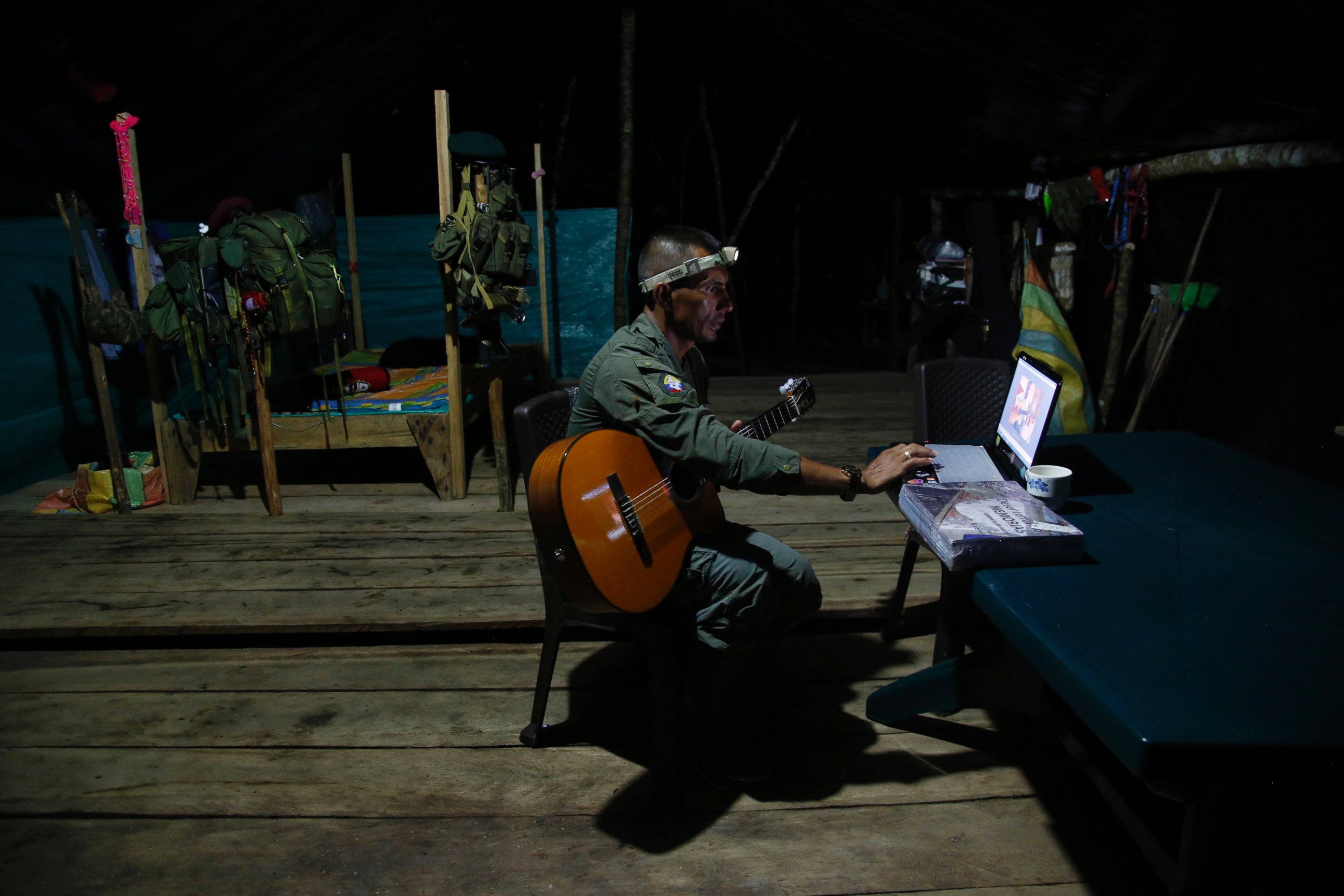 PHOTO: Manuel, a mid-level commander for the 48th Front of the Revolutionary Armed Forces of Colombia, or FARC, learns to play his guitar via the internet at a FARC encampment in the southern jungles of Putumayo, Colombia, Aug. 11, 2016.