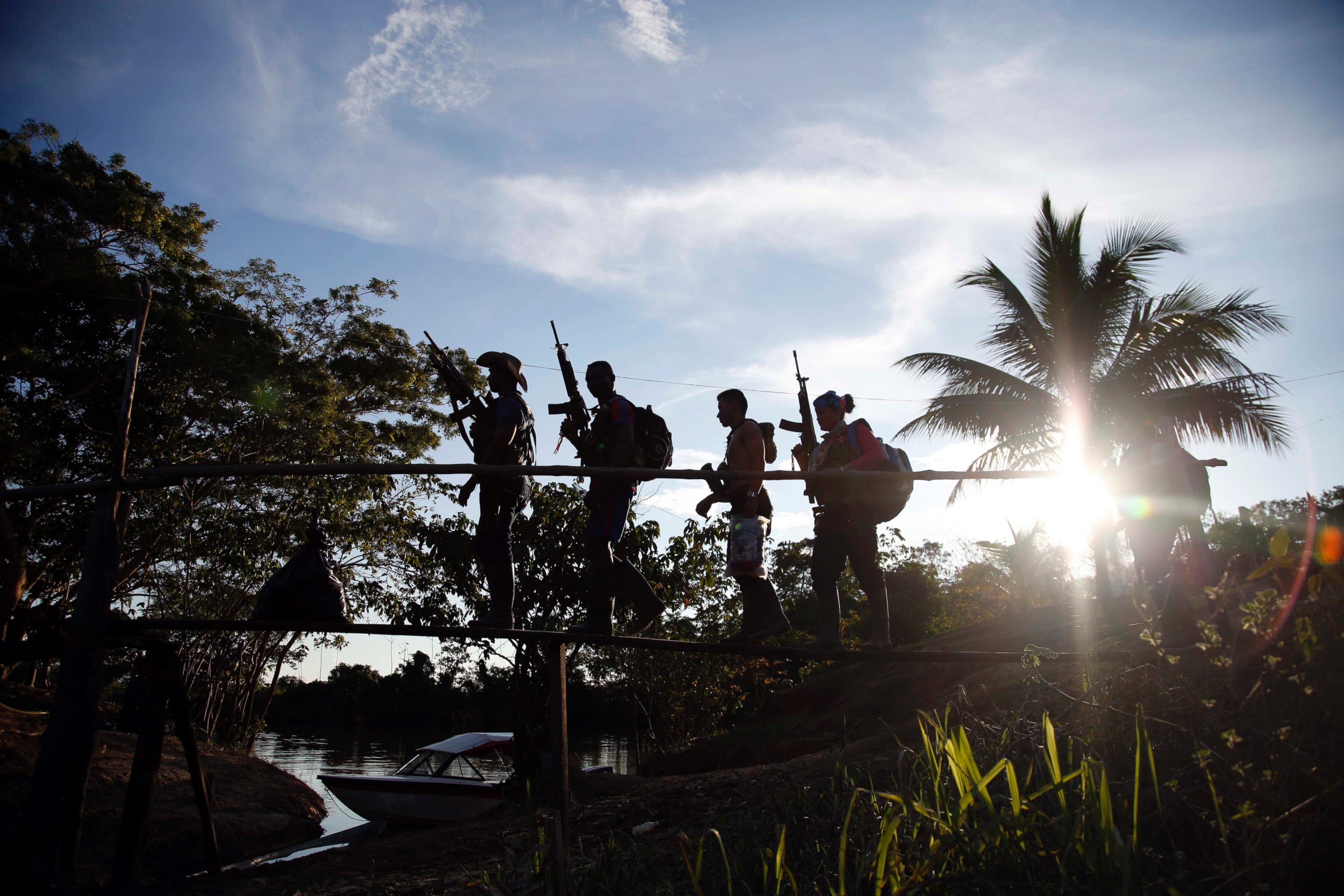 PHOTO: Rebels of the 48th Front of the Revolutionary Armed Forces of Colombia walk on a makeshift footbridge in the southern jungles of Putumayo, Colombia, Aug. 11, 2016.