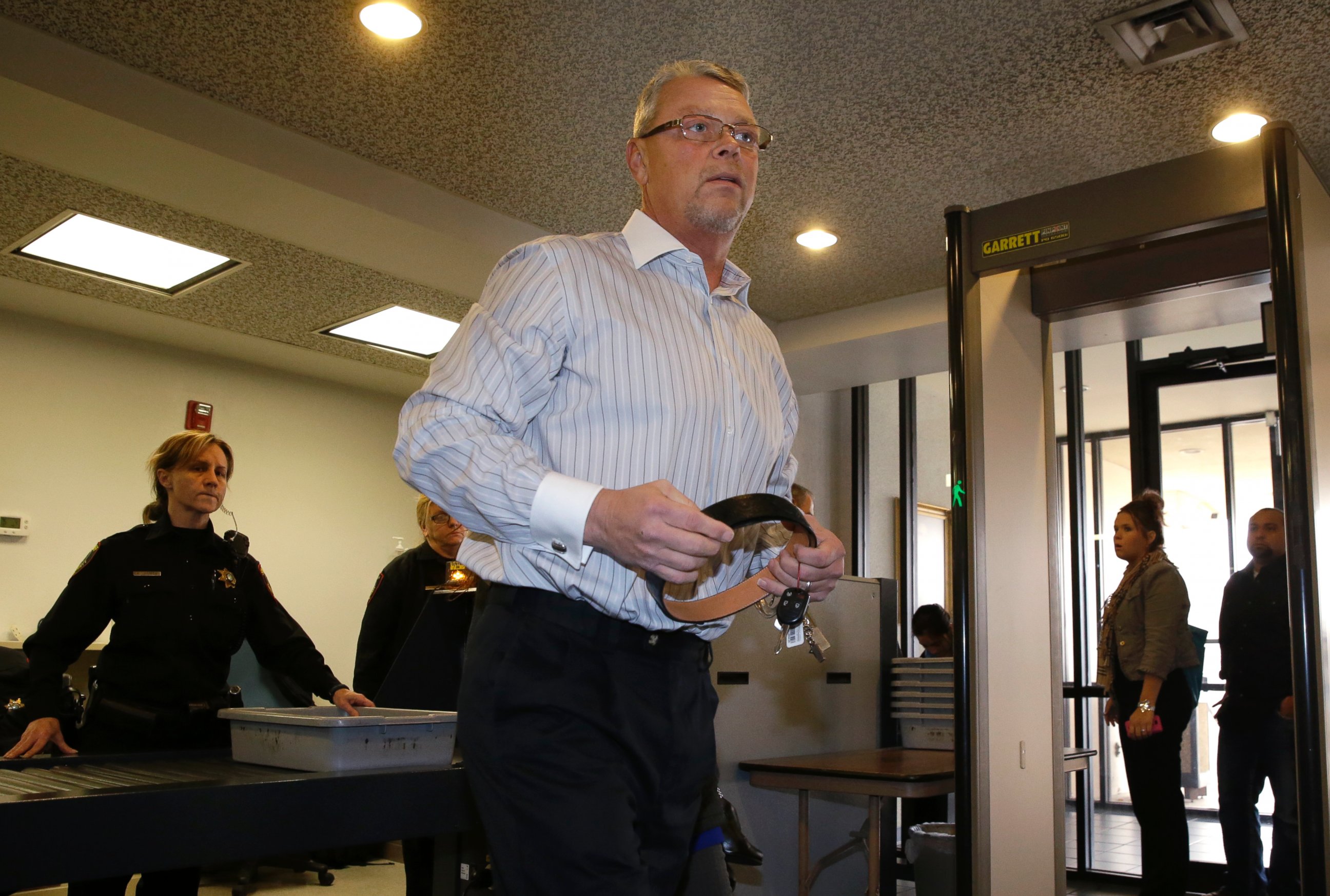 PHOTO: Fred Couch, father of "affluenza" teen Ethan Couch, collects his belt after clearing security as he arrives at juvenile court, Feb. 5, 2014, in Fort Worth, Texas.