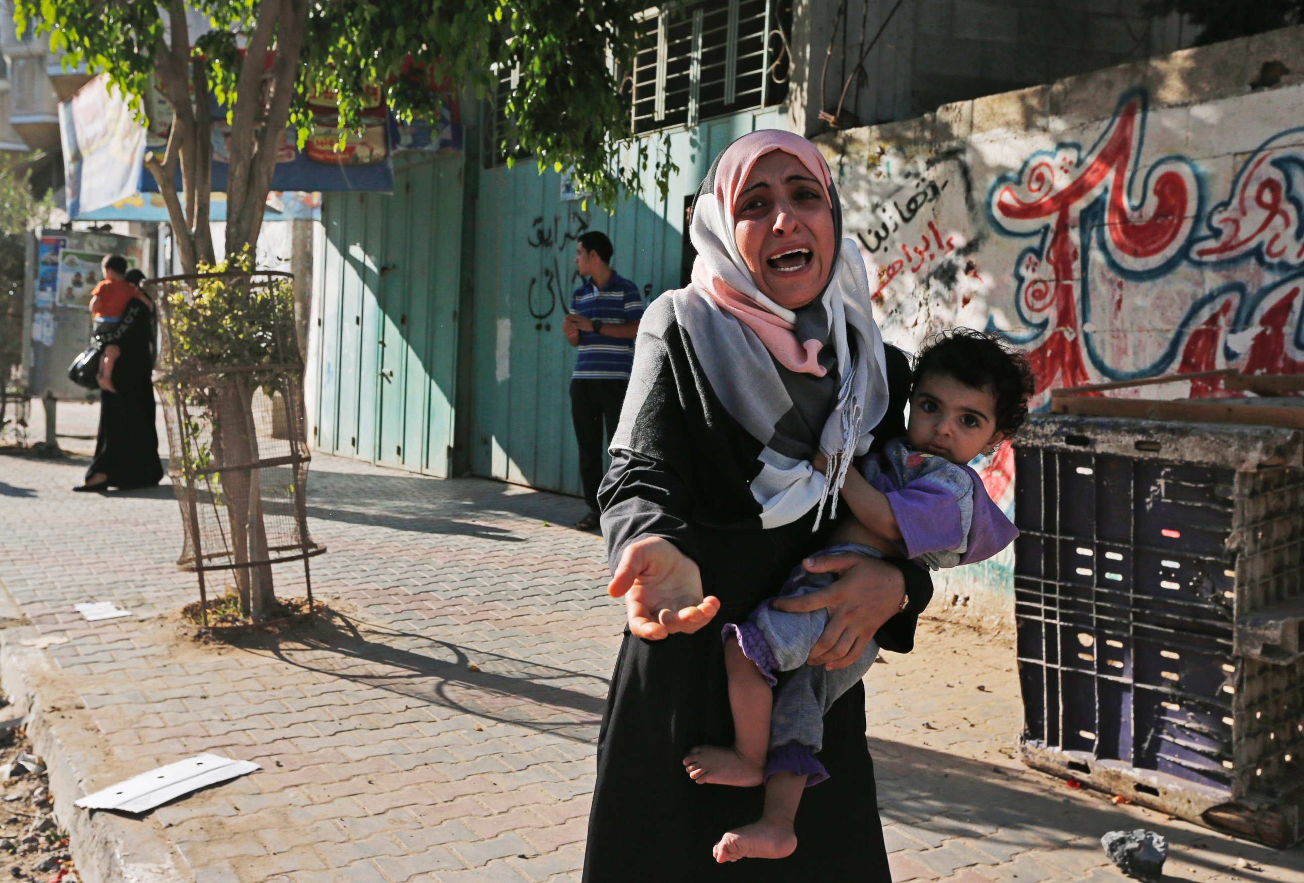 PHOTO: A woman cries as Palestinians flee their homes in the Shajaiyeh neighborhood of Gaza City, after Israel had airdropped leaflets warning people to leave the area,  July 16, 2014. 