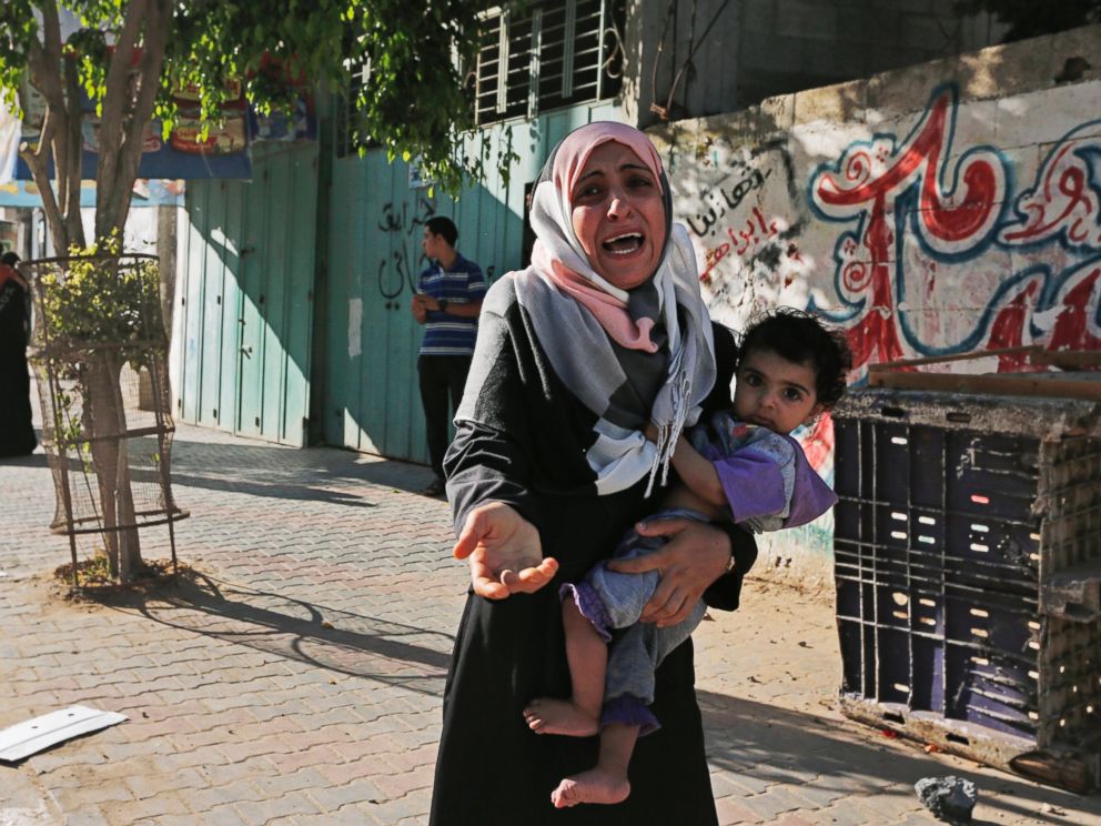 PHOTO: A woman cries as Palestinians flee their homes in the Shajaiyeh neighborhood of Gaza City, after Israel had airdropped leaflets warning people to leave the area, July 16, 2014.