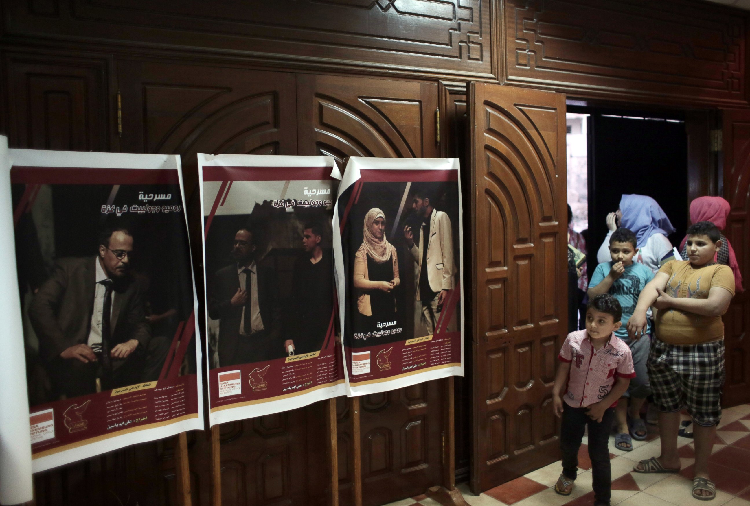 PHOTO: A Palestinian family looks at posters of the Gaza version of Shakespeare?s "Romeo and Juliet" at a cultural center in Gaza City, April 28, 2016.
