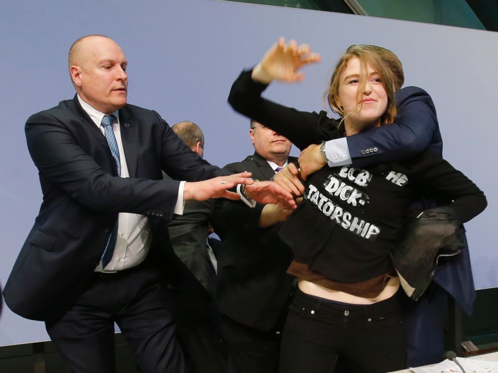 PHOTO: An activist is carried away after attacking ECB President Mario Draghi during a press conference of the European Central Bank, ECB, in Frankfurt, Germany, April 15, 2015. 