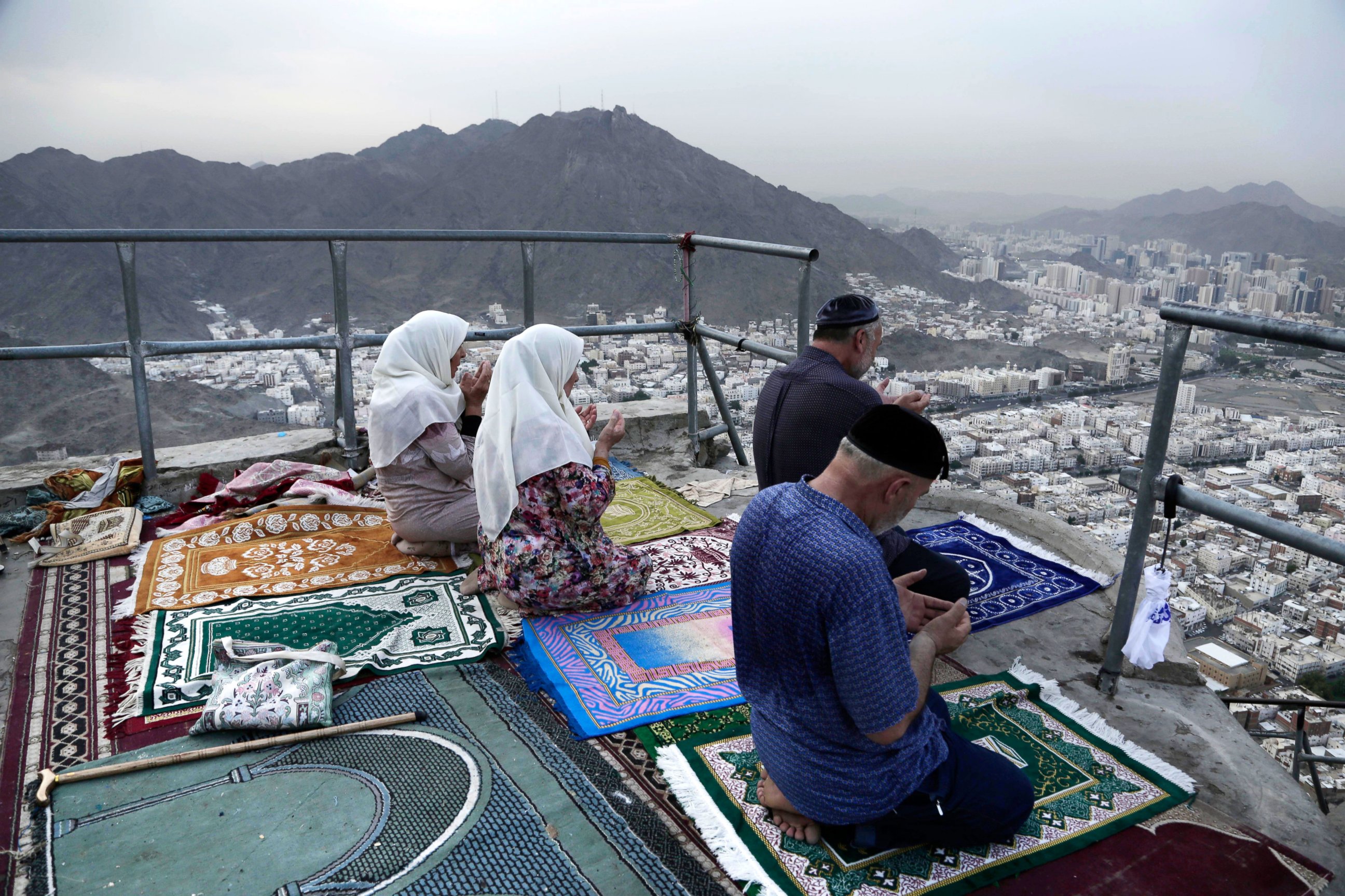 PHOTO: Chechens pray atop of Noor Mountain, where Prophet Muhammad received his first revelation from God to preach Islam, as Egyptians at right watch the view, on the outskirts of Mecca, Saudi Arabia, Sept. 9, 2016.