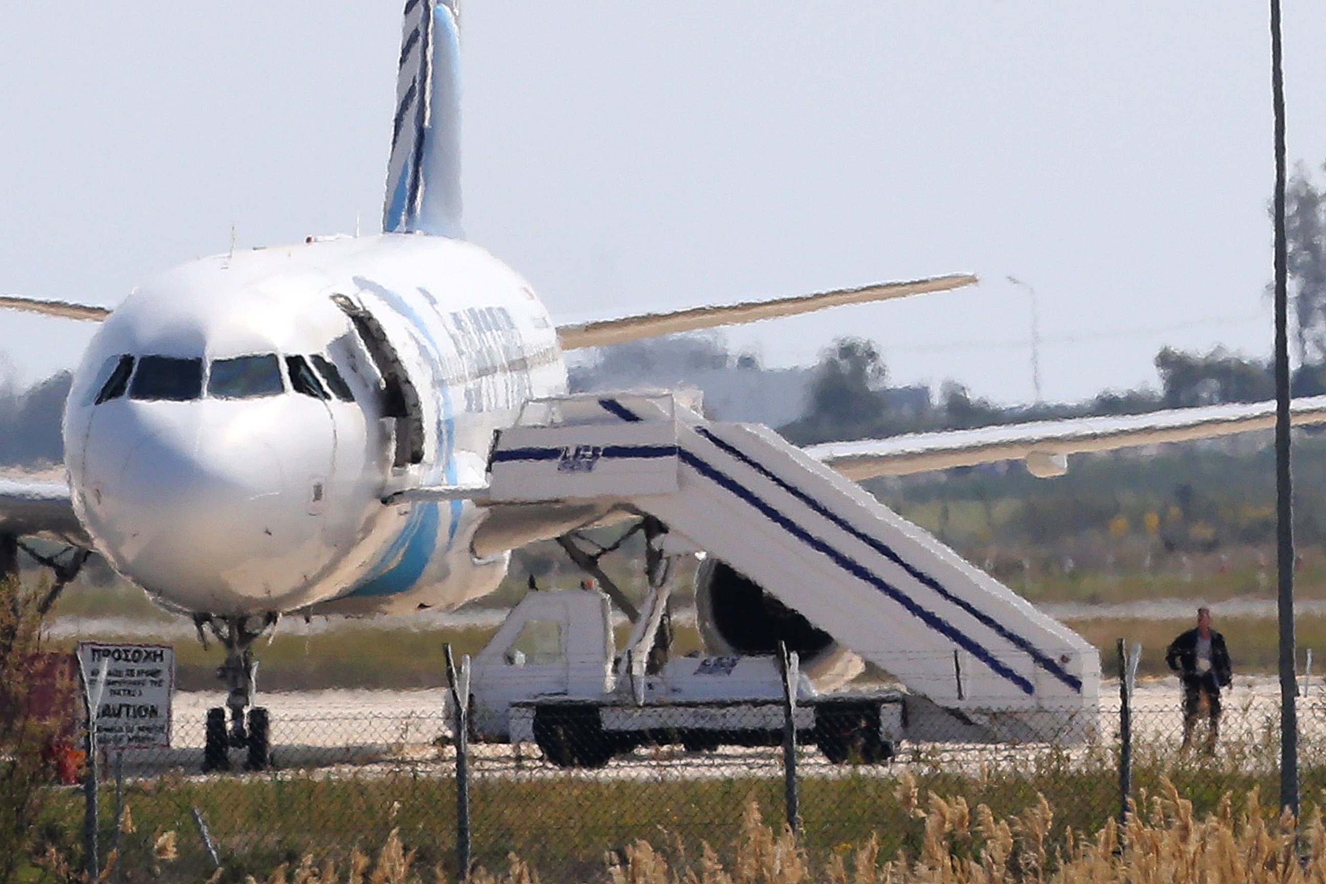 PHOTO: A man leaves the hijacked Egyptair plane at Larnaca airport on the island of Cyprus, March 29, 2016.