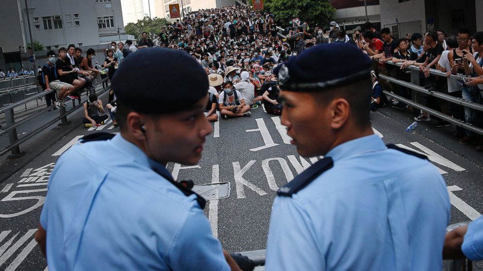 PHOTO: Pro-democracy protesters sit on a road as they face-off with local police, Sept. 29, 2014 in Hong Kong.