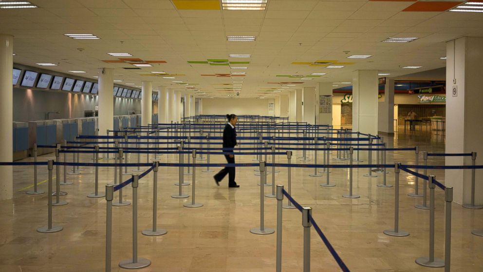 An airline employee walks through an empty airport where all flights are cancelled as Hurricane Patricia approaches the Pacific resort city Puerto Vallarta, Mexico, Oct. 23, 2015.