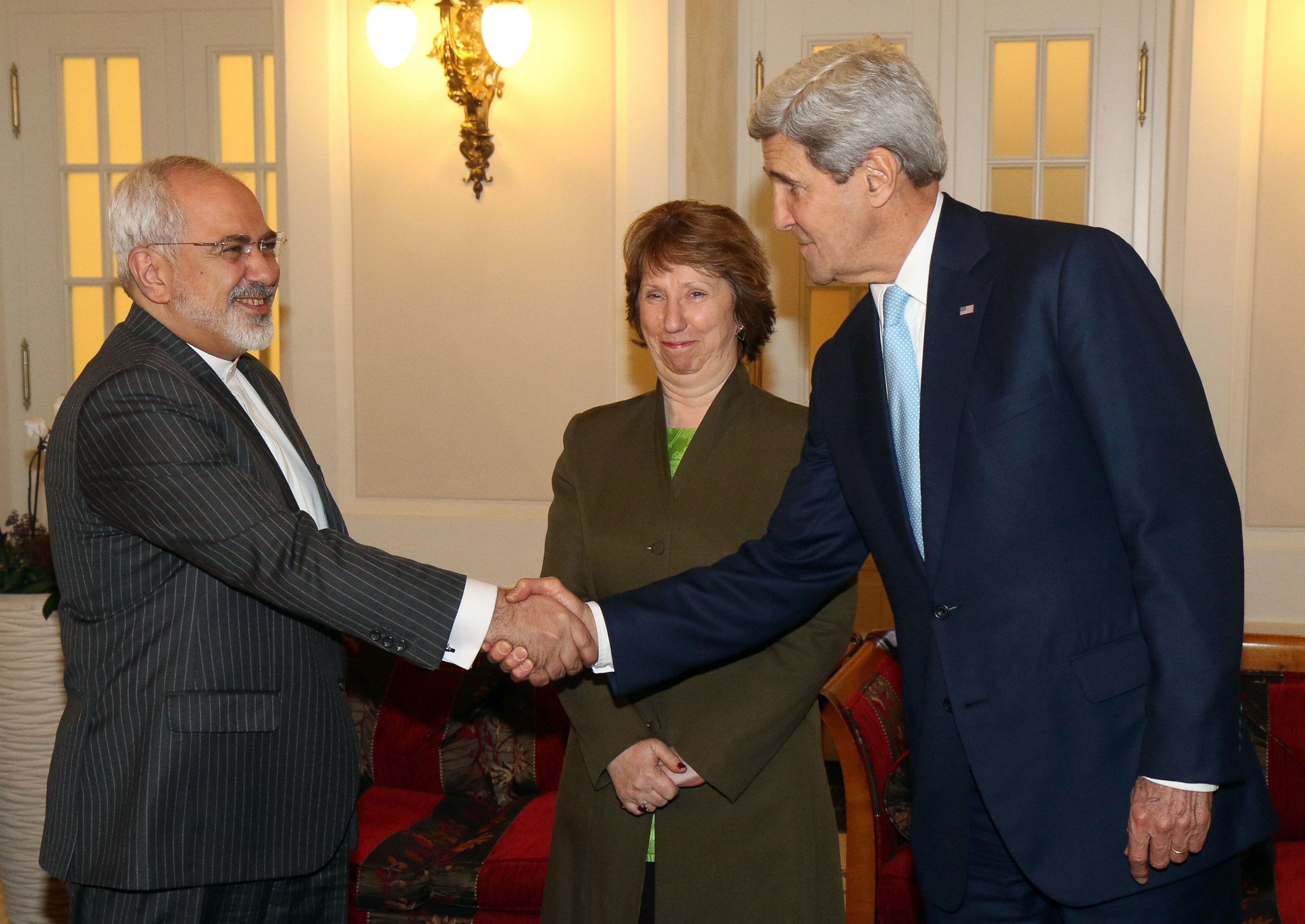 PHOTO: Iranian Foreign Minister Mohammad Javad Zarif shakes hands with U.S. Secretary of State John Kerry as former EU foreign policy chief Catherine Ashton looks prior to closed-door nuclear talks with Iran in Vienna, Austria, Nov. 20, 2014.