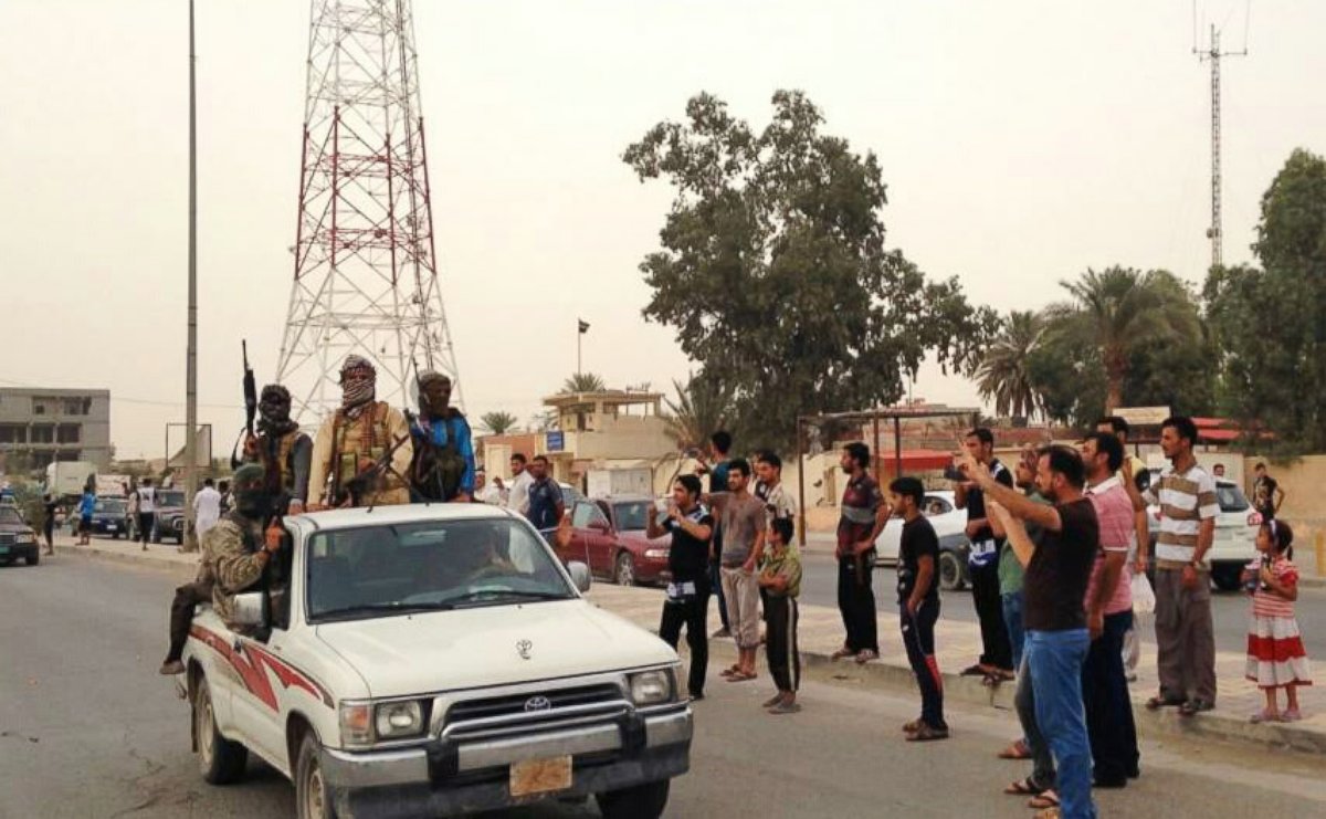 PHOTO: In this July 29, 2014 photo, Islamic militants parade in Beiji, Iraq.
