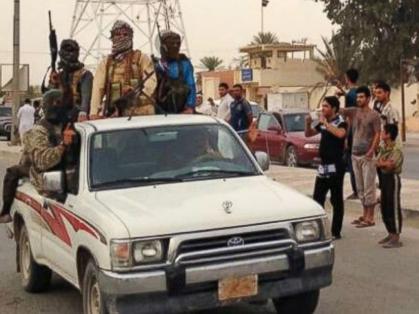 PHOTO: In this July 29, 2014 photo, Islamic militants parade in Beiji, Iraq.