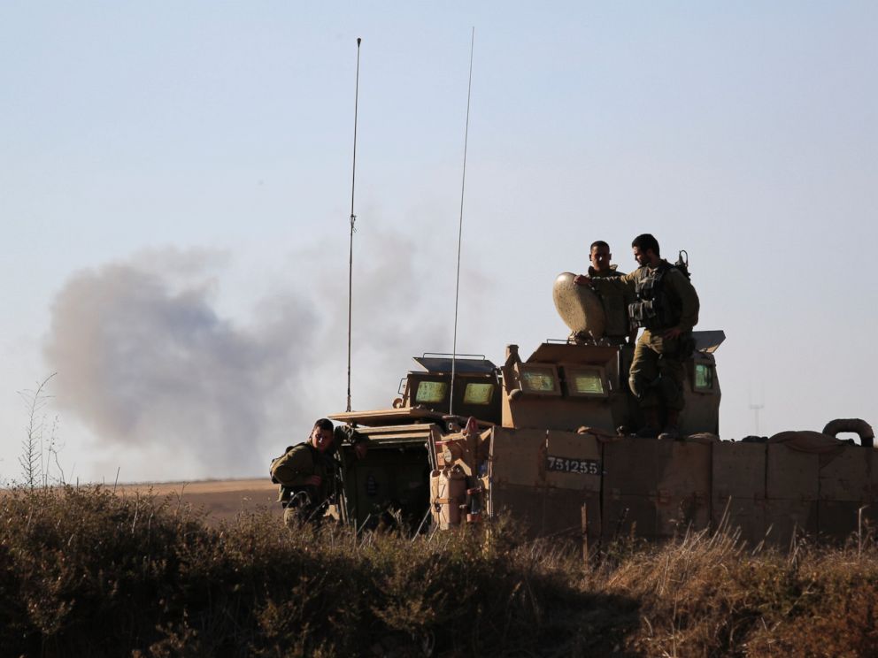 PHOTO: Israeli soldiers look on the site near the Israeli Gaza border, where a man was injured from a mortar shell fired from the Gaza Strip, Sunday, Aug, 3, 2014.