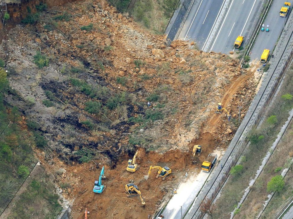 PHOTO: Heavy machinery works recovery efforts of Oita Expressway damaged by a landslide following an earthquake in Yufu, Oita prefecture, Japan, April 16, 2016.