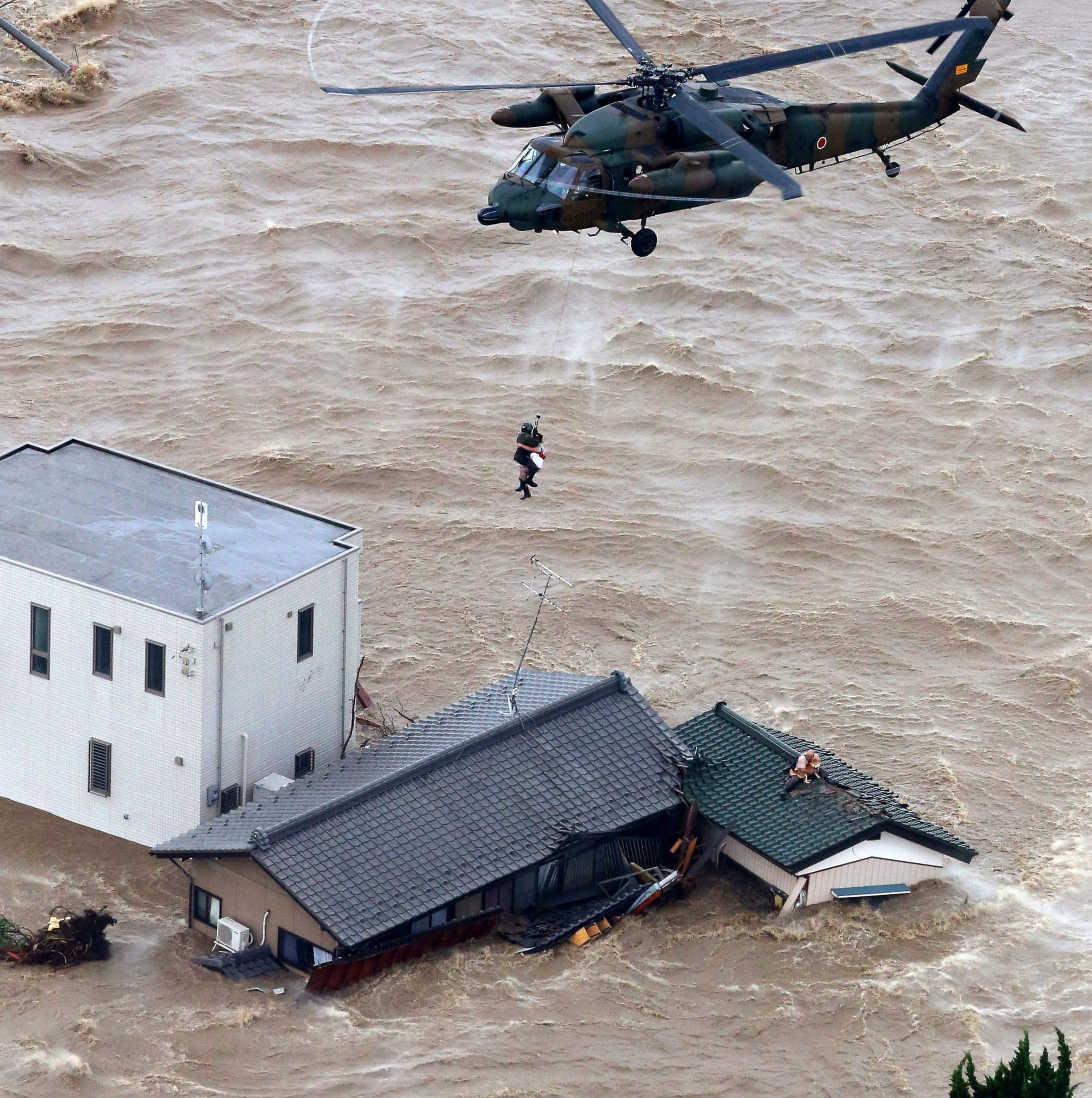 PHOTO: A resident is rescued from a flooded residential area in Joso, Ibaraki prefecture, northeast of Tokyo, Sept. 10, 2015. 
