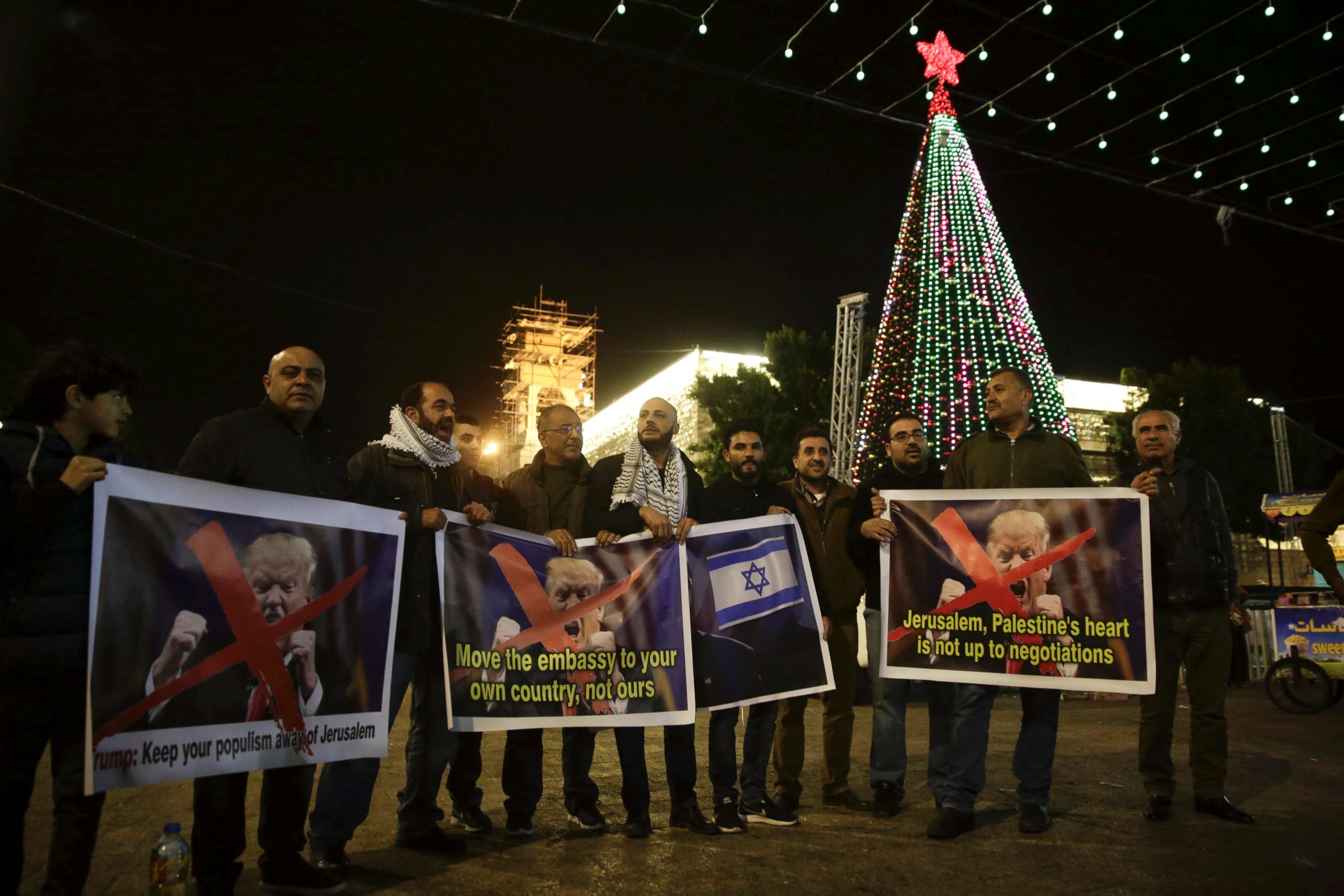 PHOTO: Palestinian hold posters of the U.S. President Donald Trump during a protest in Bethlehem, West Bank, Tuesday, Dec. 6, 2017.