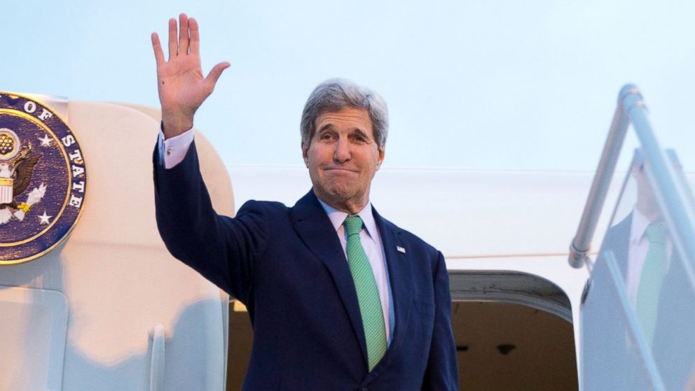 U.S. Secretary of State John Kerry waves as he boards his plane at Orly Airport, south of Paris, France, Oct. 15, 2014, en route to Vienna, Austria.