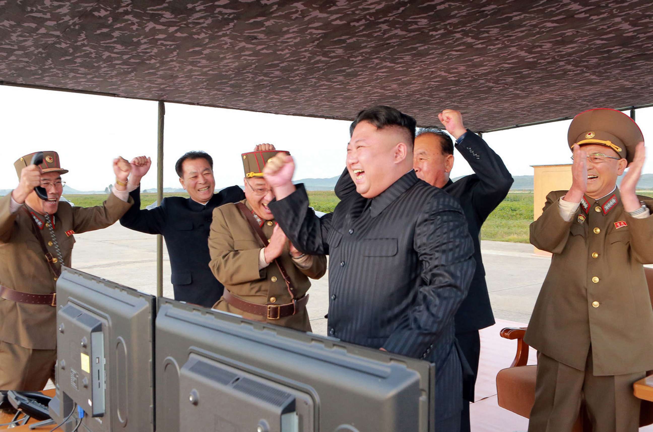 PHOTO: In this undated photo distributed on Sept. 16, 2017, by the North Korean government, leader Kim Jong Un, center, celebrates what was said to be the test launch of an intermediate range Hwasong-12 missile at an undisclosed location in North Korea.
