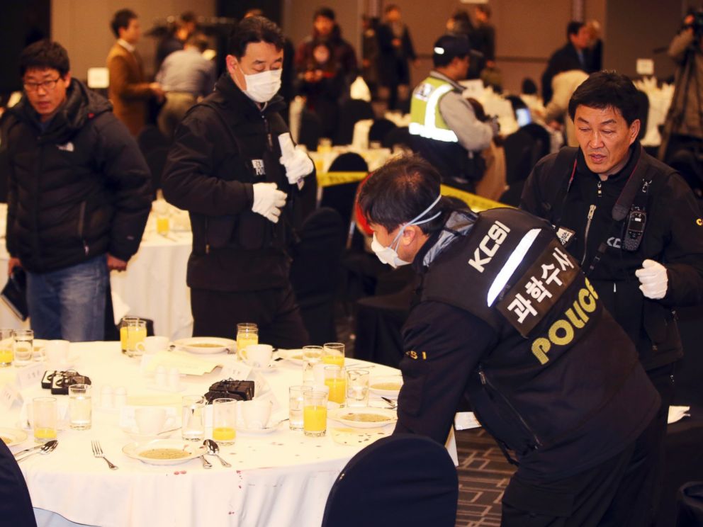 PHOTO: Police officers investigate the table where U.S. Ambassador to South Korea Mark Lippert sat at a lecture hall in Seoul, South Korea, March 5, 2015.