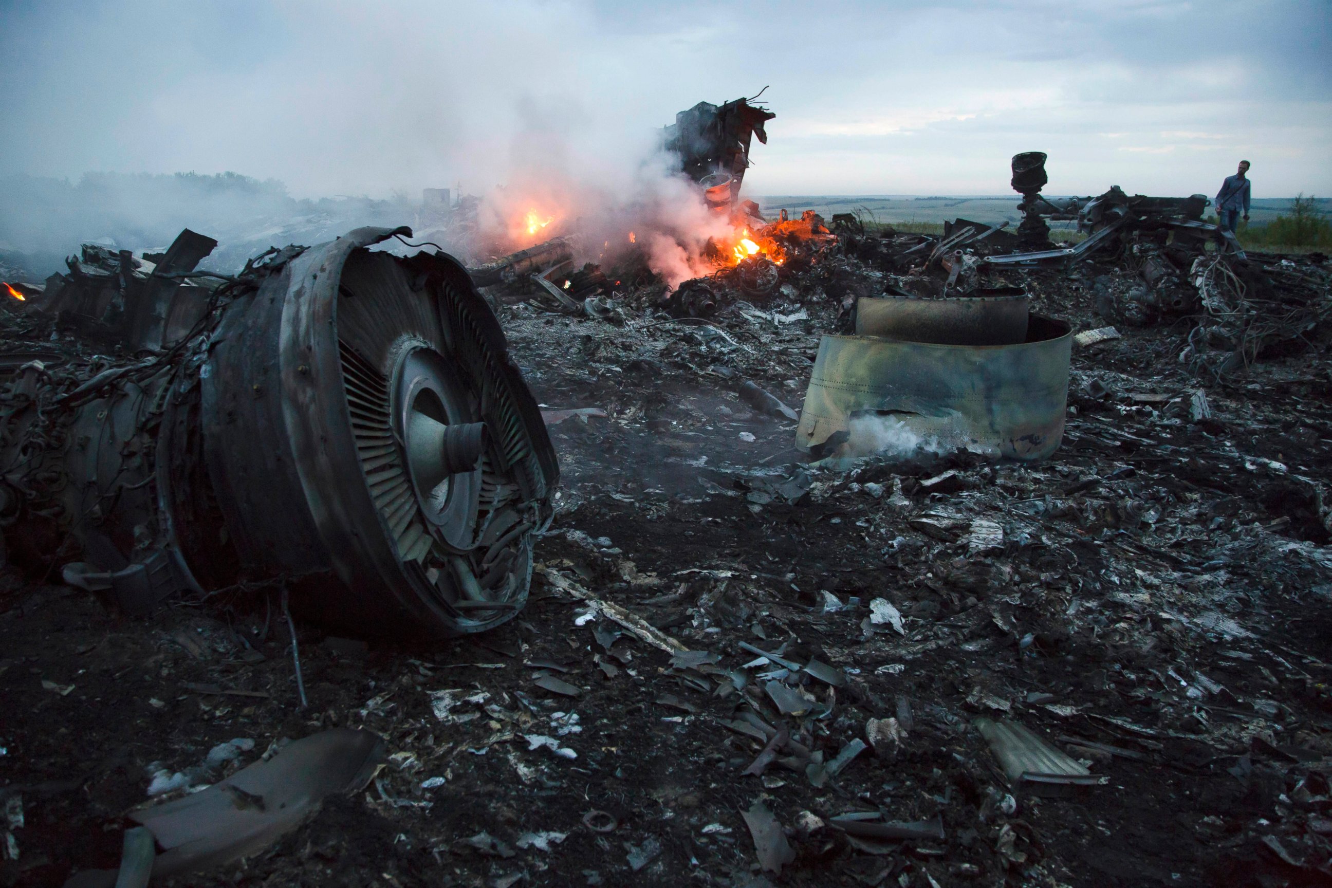 PHOTO: A man walks amongst the debris at the crash site of a passenger plane Malaysia MH17 near the village of  Hrabove, Ukraine, July 17, 2014.