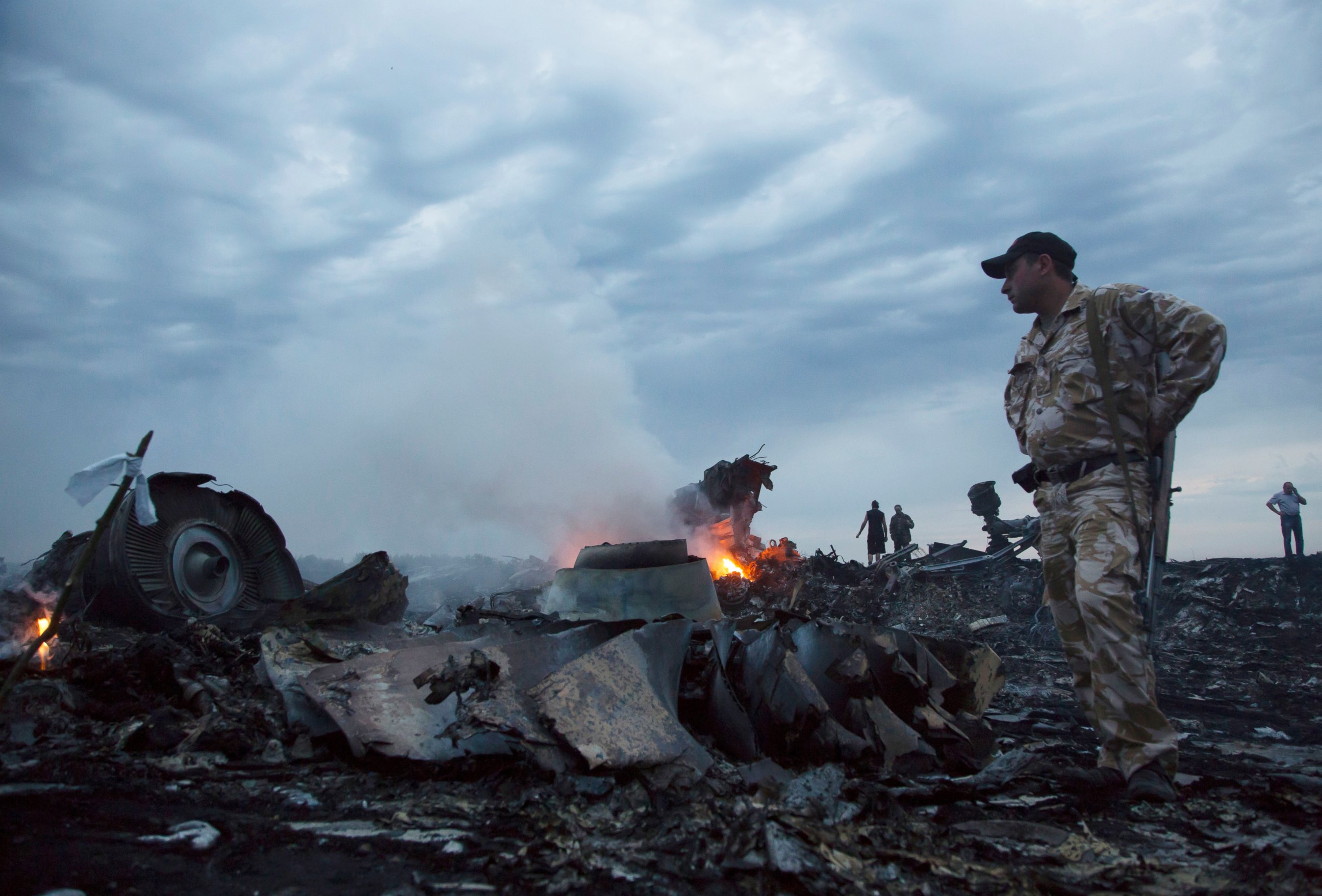 PHOTO: People walk amongst the debris, at the crash site of a passenger plane near the village of Grabovo, Ukraine, July 17, 2014.  