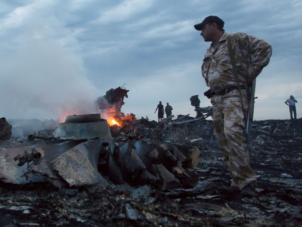 PHOTO: People walk amongst the debris, at the crash site of a passenger plane near the village of Grabovo, Ukraine, July 17, 2014.