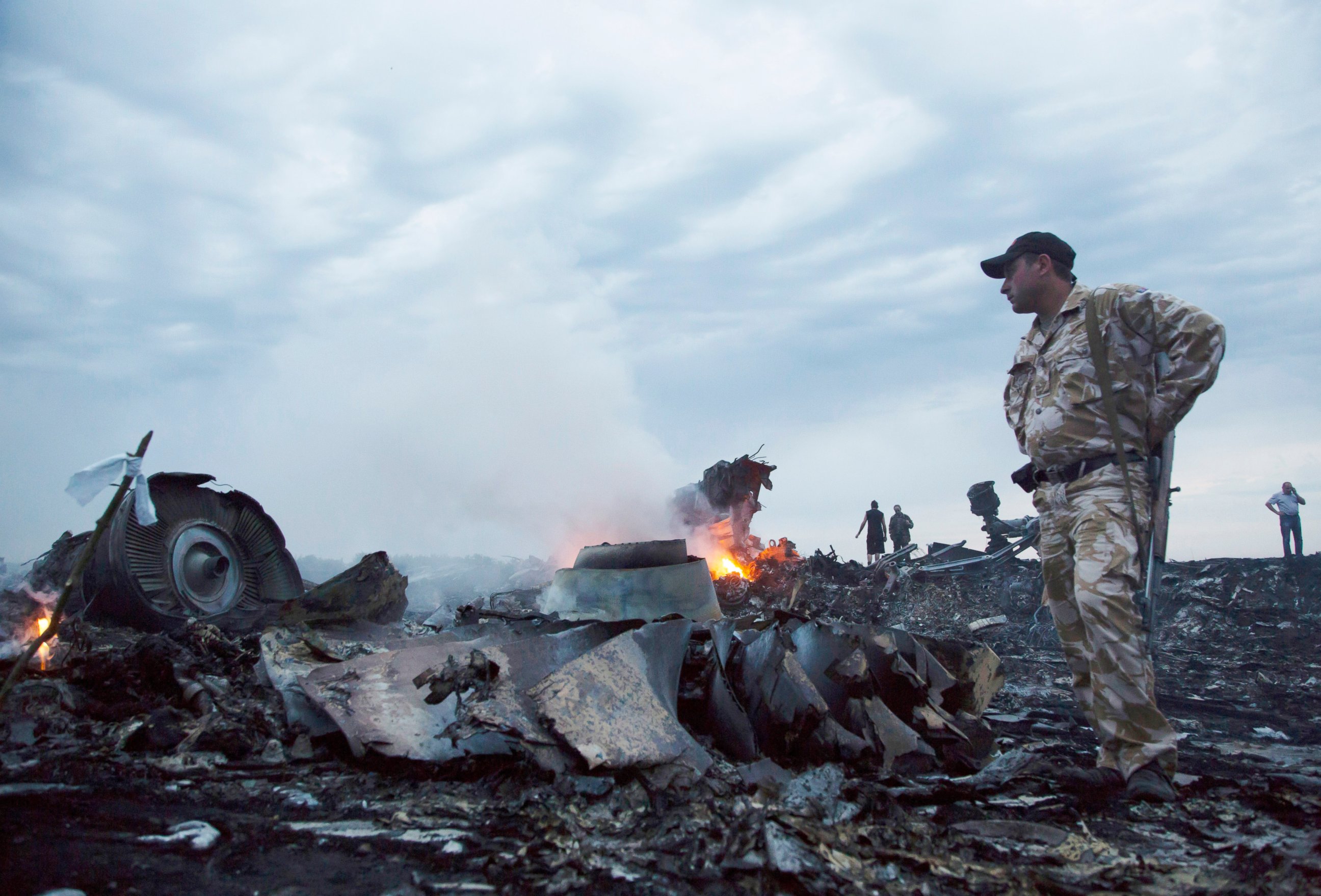 PHOTO: People walk amongst the debris, at the crash site of a passenger plane near the village of Grabovo, Ukraine, July 17, 2014.  