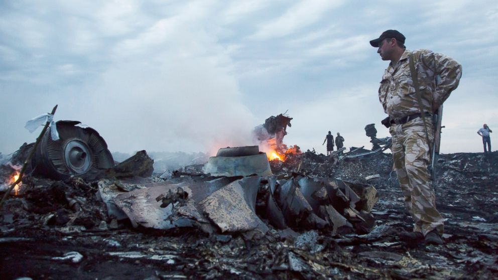 PHOTO: People walk amongst the debris, at the crash site of a passenger plane near the village of Grabovo, Ukraine, July 17, 2014.  