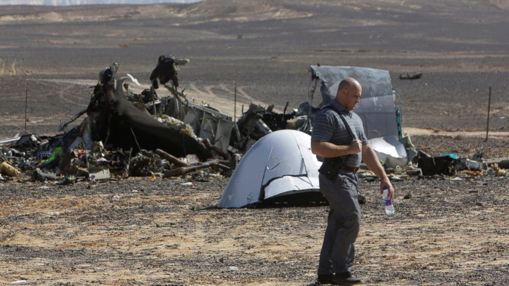 A Russian investigator walks near wreckage a day after a passenger jet bound for St. Petersburg, Russia, crashed in Hassana, Egypt, Nov. 1, 2015. 