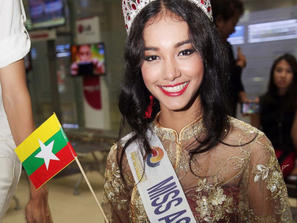 PHOTO: In this June 5, 2014 file photo, Myanmar model May Myat Noe, winner of Miss Asia Pacific World 2014 pageant, waves a miniature flag of the country upon her arrival at Yangon International Airport in Yangon, Myanmar.