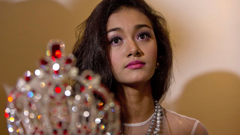 May Myat Noe, Myanmar's first international beauty queen, winner of the 2014 Miss Asia Pacific World, sits with her crown that she allegedly ran away with, during a press conference in Yangon, Myanmar, Sept. 2, 2014.